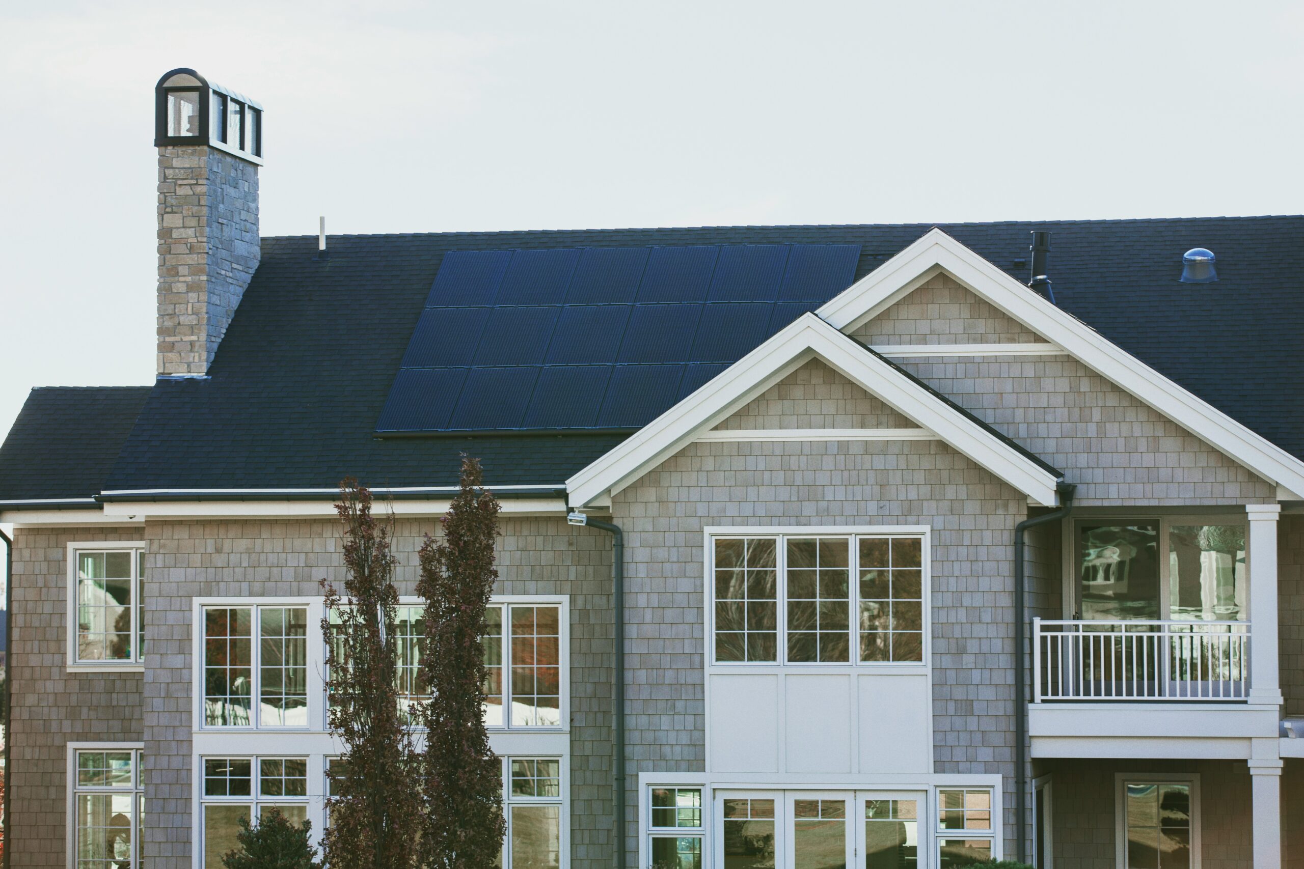 Newly built suburban home with solar panels installed on the roof, representing post-COVID construction and sustainable energy upgrades.